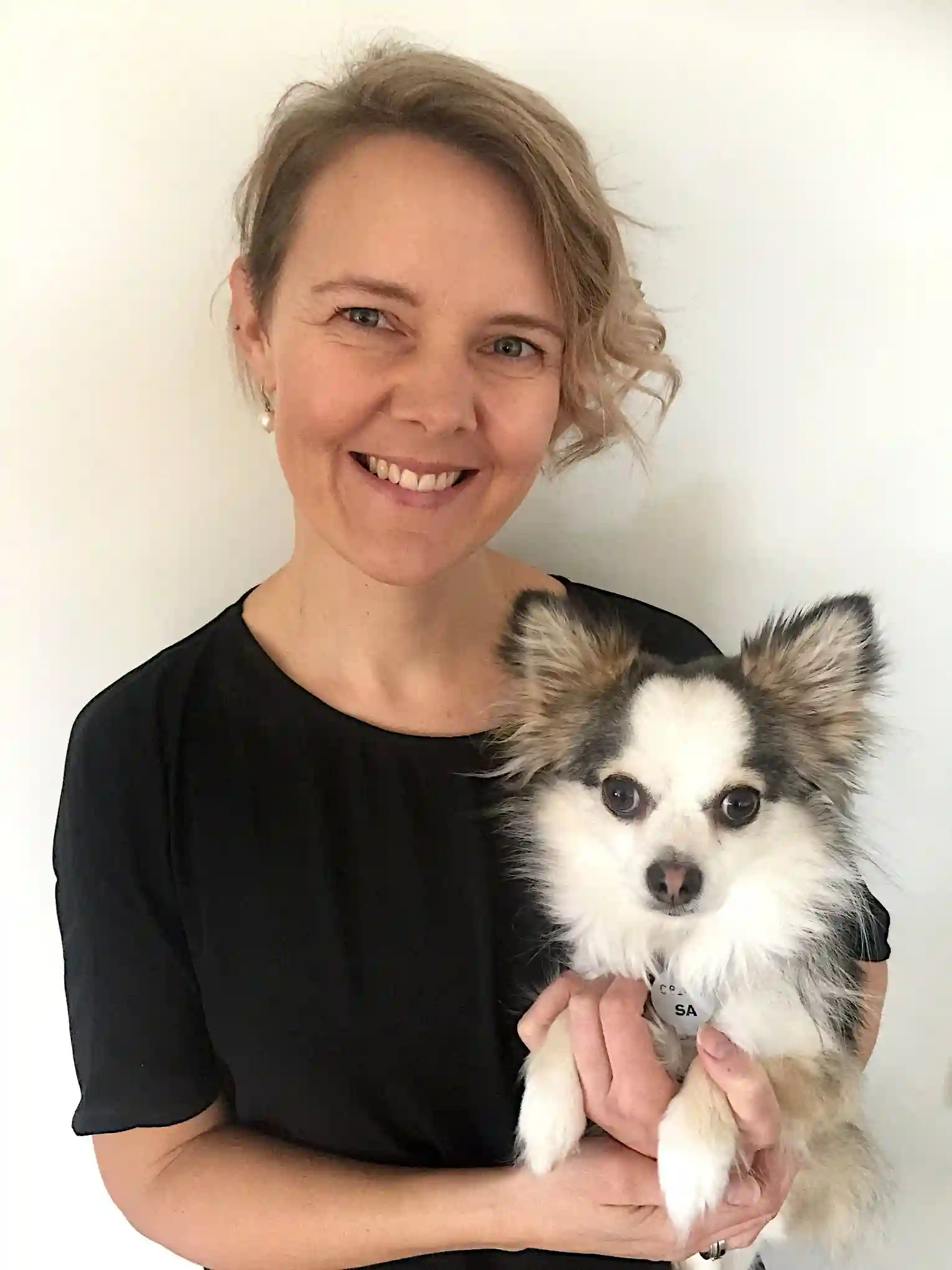 Dr. Kirsten holding a small dog