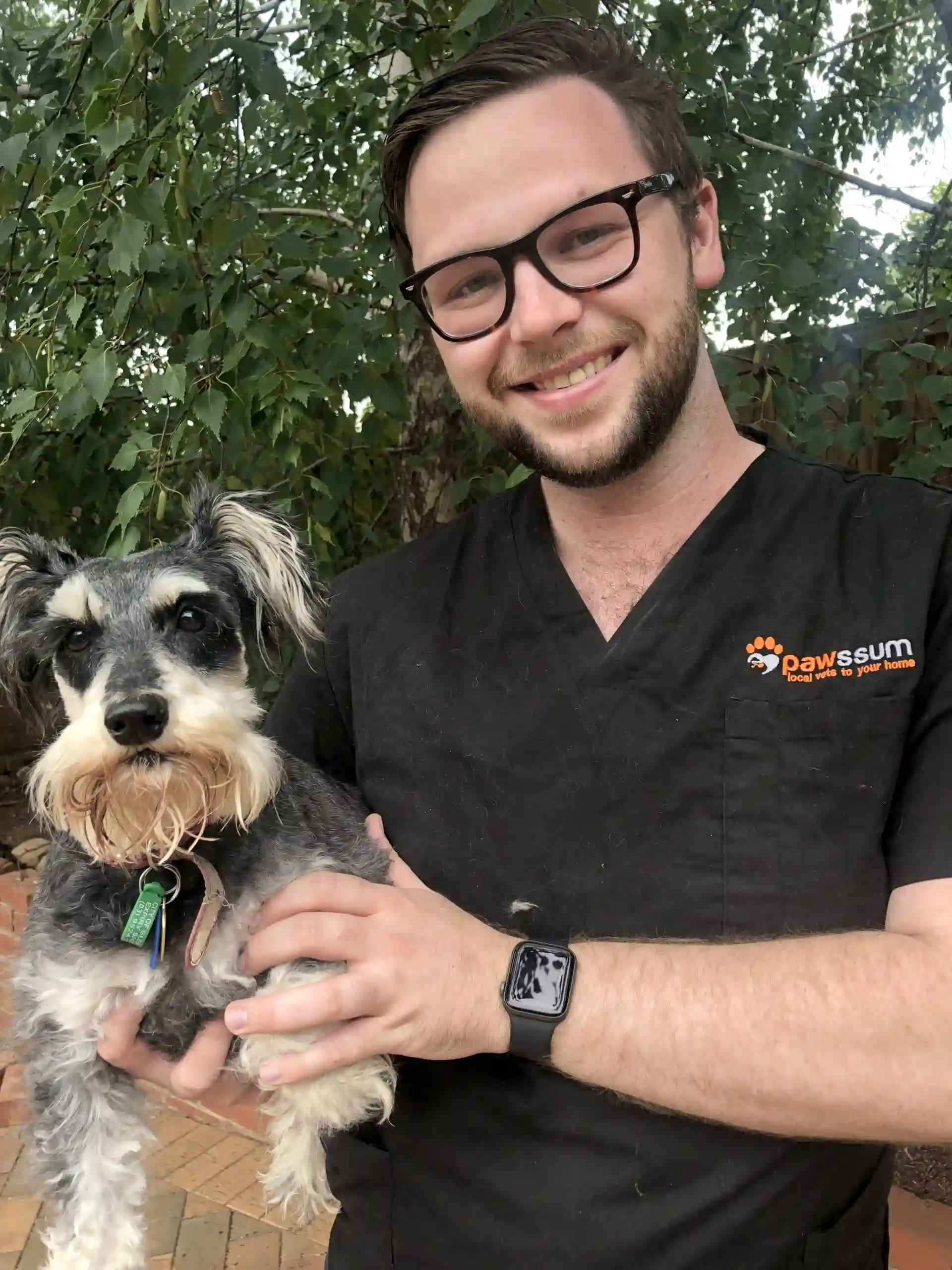 Dr. Kris holding a terrier dog
