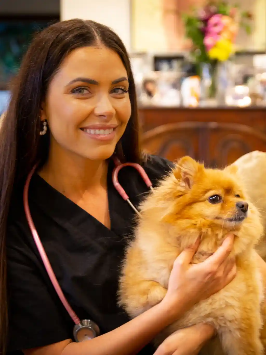 Dr. Olivia with a little fluffy dog