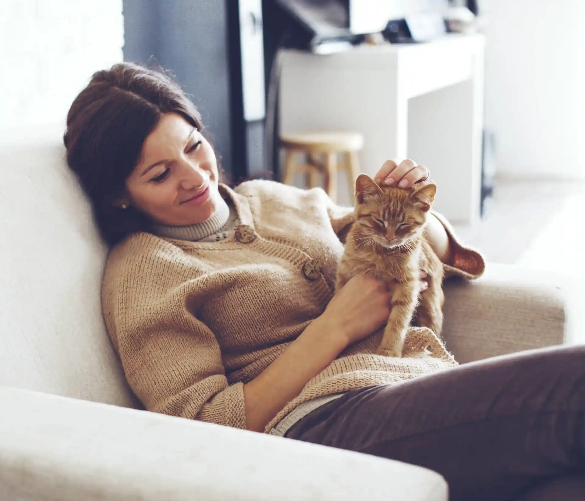 Woman in armchair with cat